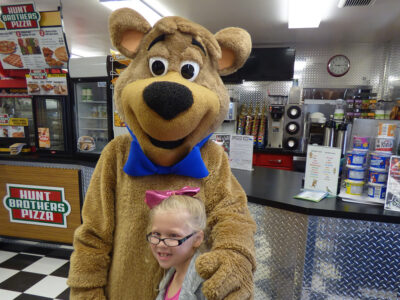 Boo Boo Bear at Cartoon Café Counter | Jellystone Park™ South Haven Boo Boo Bear greeting guests at the Cartoon Café counter at Jellystone Park™ South Haven