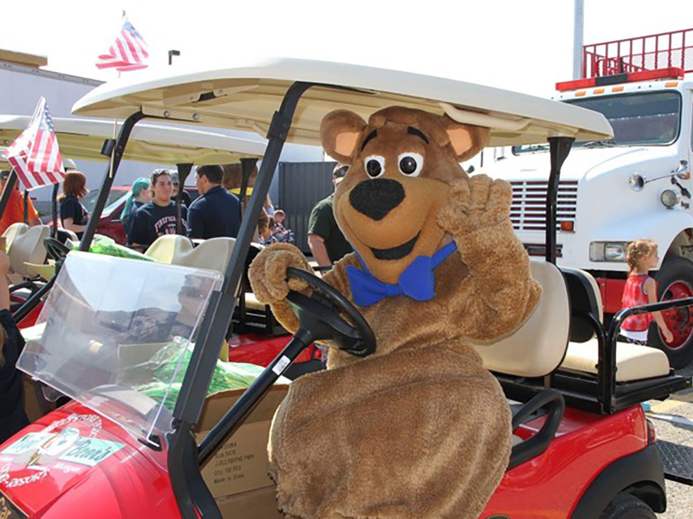 Boo Boo Bear sitting in a golf cart at Jellystone Park South Haven