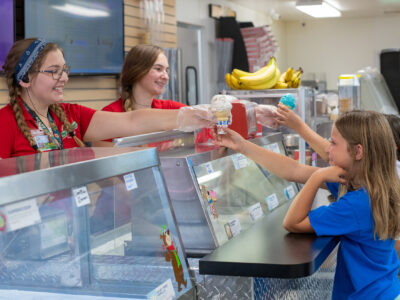 Cartoon Café Ice Cream Service at Jellystone Park™ South Haven Child receiving ice cream from staff at Cartoon Café in Jellystone Park South Haven